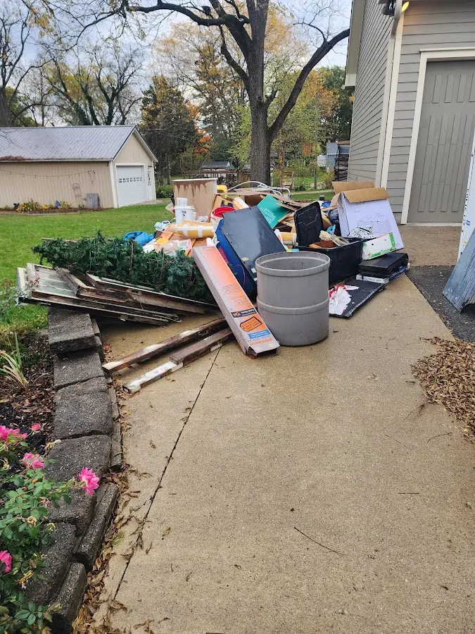 Dumpster being loaded with debris for Residential Dumpster Rental in Emerald Mountain